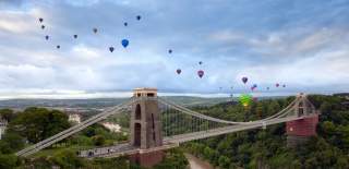 Balloons flying over the Clifton Suspension Bridge in West Bristol during one of the morning mass ascents from the Bristol Balloon Fiesta - credit Gary Newman