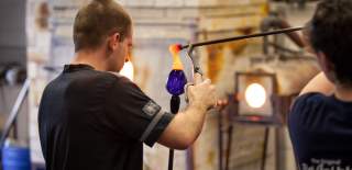 A staff member shaping a glass object at Bristol Blue Glass - credit Bristol Blue Glass