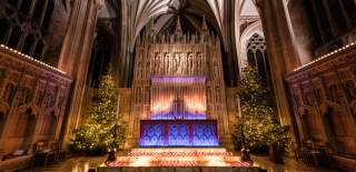 Bristol Cathedral alter with Christmas trees and candles  - Credit Bristol Cathedral