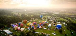 A group of balloons lifting off in a mass ascent at Bristol International Balloon Fiesta - credit Adam Gasson