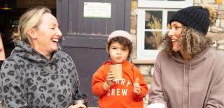 Two women and a child at the cafe at Bristol Zoo Project