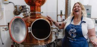Person stood next to gin still at 6 O'Clock Gin distillery - credit Visit West