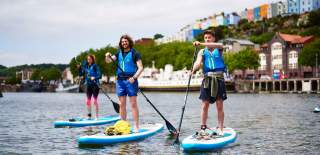 Group on paddelboards in Bristol harbour - credit SUP Bristol