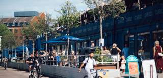 An aerial view of people dining alfresco at Wapping Wharf on Bristol's Harbourside - credit Shotaway