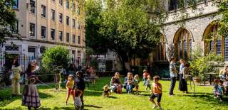 Children playing outside St Stephens Church during Old City Sounds 2024 in Bristol - Credit Julian Preece / Bristol City Centre BID