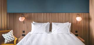 Double bed with chair - Credit Mollie's Motel and Diner
