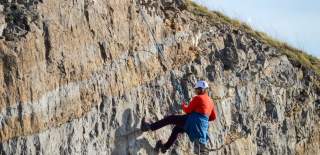 Person abseiling down cliff - credit Up & Under Adventures