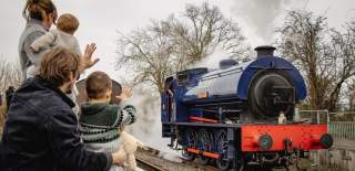 Family waving at train at Avon Valley Railway near Bristol - credit Avon Valley Railway