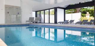 Indoor pool with loungers at Foxhills Spa - credit Old Down Estate