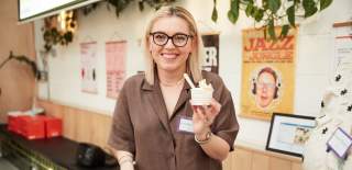 Person holding up cup of gelato - credit Charlotte Tolhurst
