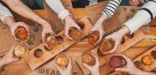 People holding glasses of cider - credit The Stable