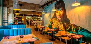 Blue booth tables and large mural at Bambalan, Bristol - credit Bambalan