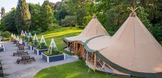 De vere Tortworth Court near Bristol exterior with outdoor seating and tipis in garden - credit De vere Tortworth Court