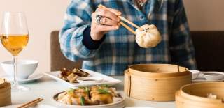 Person with dumpling on chopsticks - credit Clouds Bristol
