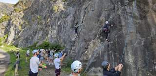 People climbing up cliff - credit Up & Under Adventures