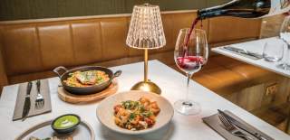Wine being poured next to food at Colonnade in central Bristol - credit Colonnade