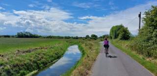 Cycling alongisde field on the Pier to Pier Cycle Route - credit Hallam Greene