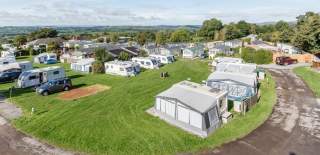 An aerial view of Bucklegrove Holiday park with tents and caravans - Credit Wookey Hole