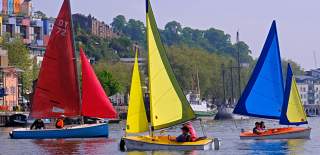 Three colourful sailboats in the Bristol Harbourside - Credit All Aboard Watersports