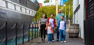 A family exploring the exterior of the SS Great Britain in the Great Western Dockyard, Bristol - credit Brunel's SS Great Britain