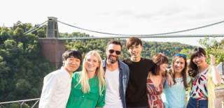 A group of international students in front of the Clifton Suspension Bridge in West Bristol - credit Roger Harris