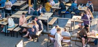 People sitting at tables at the Junction bar - credit Hey What