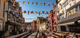 A view of the eastern end of King Street in central Bristol, with the historic Llandoger Trow pub on the left and the modern King Street Brew House on the right