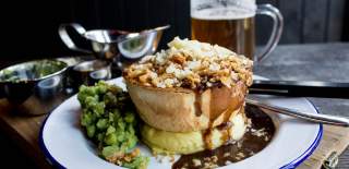 Pie, mash, peas and gravy on a plate