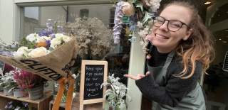Woman pointing at flowers - credit Bristol Floral Design