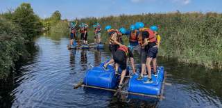 A group of men trying raft building at Mendip Activity Centre near Bristol - credit Mendip Activity Centre