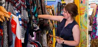 A woman browsing inside the 'Something Elsie' clothing shop in Wapping Wharf on Bristol's Harbourside - credit Hey What