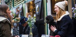 A stallholder and a customer at St Nicholas Market in Bristol's Old City - credit Paul Box