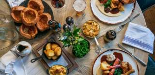 A selection of Sunday roasts on a table at Ring O' Bells pub in Compton Martin, near Bristol - credit The Ring O'Bells