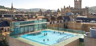 An aerial view of the rooftop pool at the Thermae Bath Spa in central Bath near Bristol, with Bath's skyline in the background