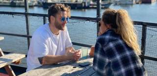 People sat on terrace at The Grain Barge in Bristol - Credit The Grain Barge
