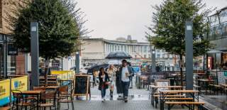 Group walking through Wapping Wharf, Bristol in the rain - credit Food Tours of Bristol