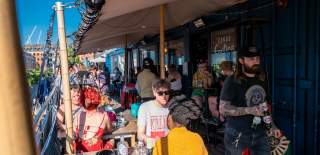 People dining outside in Wapping Wharf on Bristol's Harbourside - credit Hey What