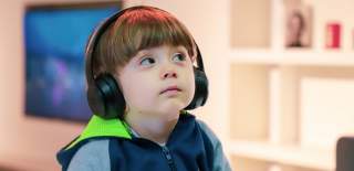 A young boy wearing headphones at the We The Curious science centre in Bristol - credit We The Curious