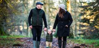 A couple walking their baby through the grounds of Westonbirt Arboretum near Bristol - credit Johnny Hathaway