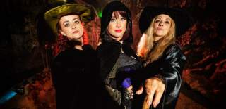 3 witches stood in a cave - Credit Wookey Hole