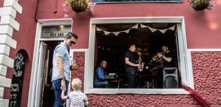 Adult and child watching a live band outside pub