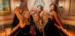 People posing for a photo at Flight Club.