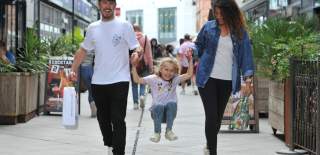 Family walking through The Brewery Quarter in Cheltenham.