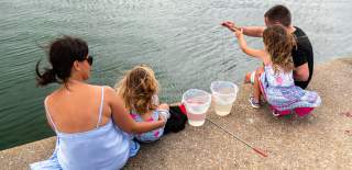A family with a crab line on the water front