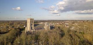 Christchurch viewed from a distance, featuring the Priory and distant horizon