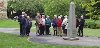 Guided tour group standing next to the Obelisk in Castle Park