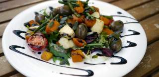 Photo of a salad, service with a balsamic glaze.