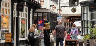 People walk through Red Lion Walk in Colchester.