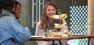 Smiling people looking at their Afternoon Tea