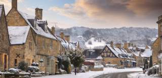 The main street in Broadway with honey-coloured stone houses dusted in snow